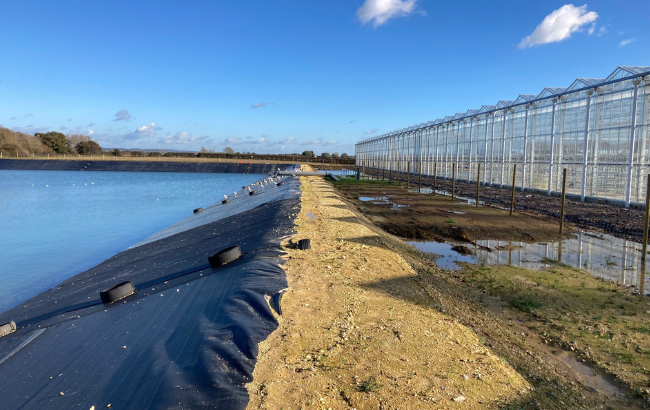 Reservoir of water next to glasshouses