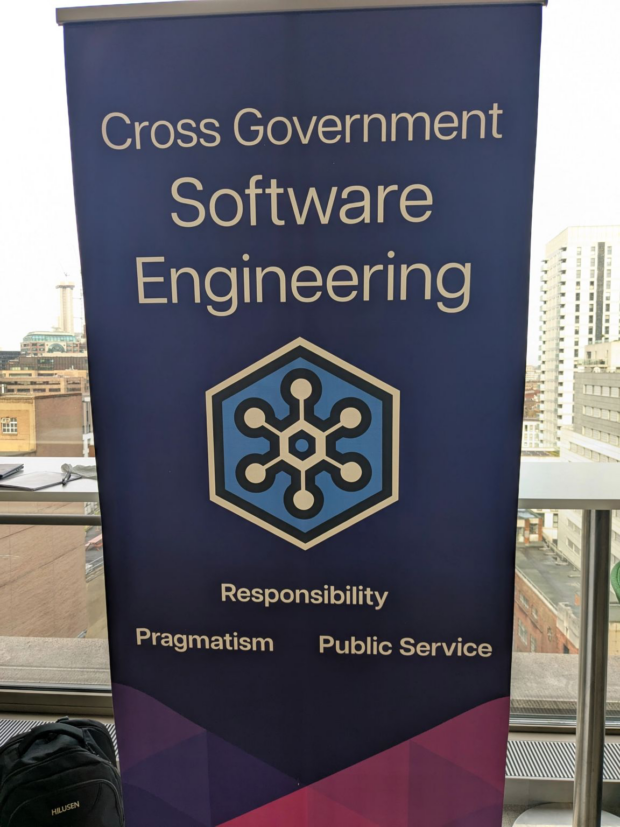 Photo of pull up banner stating cross government software engineering