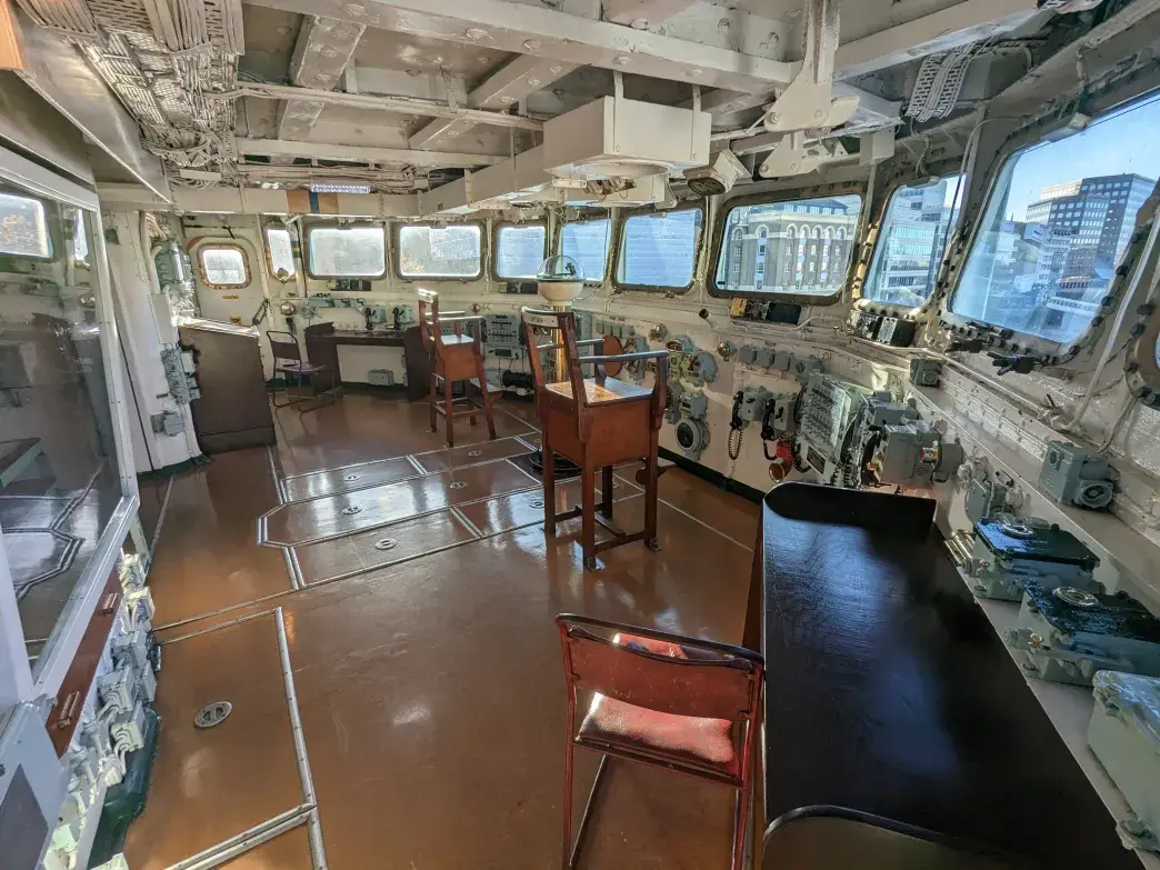 Wide enclosed bridge overlooking the ship’s fo’c’sle and forward guns.