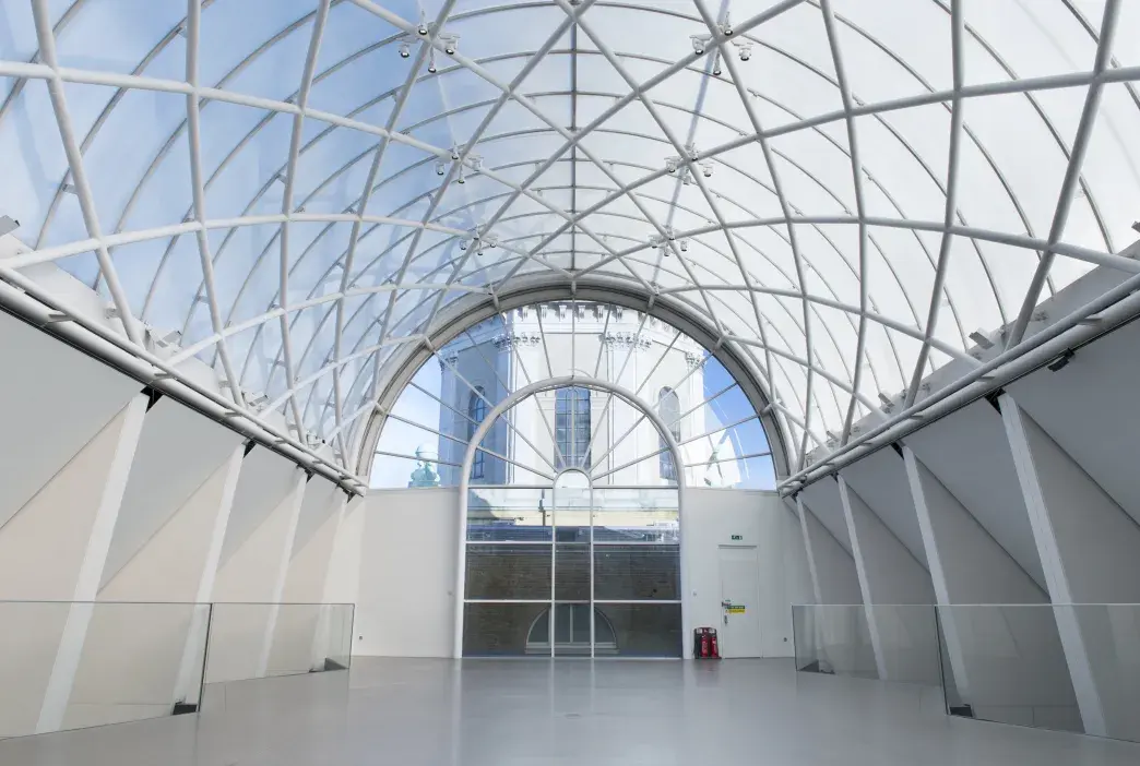 Wide, light, roof terrace with a glass roof.