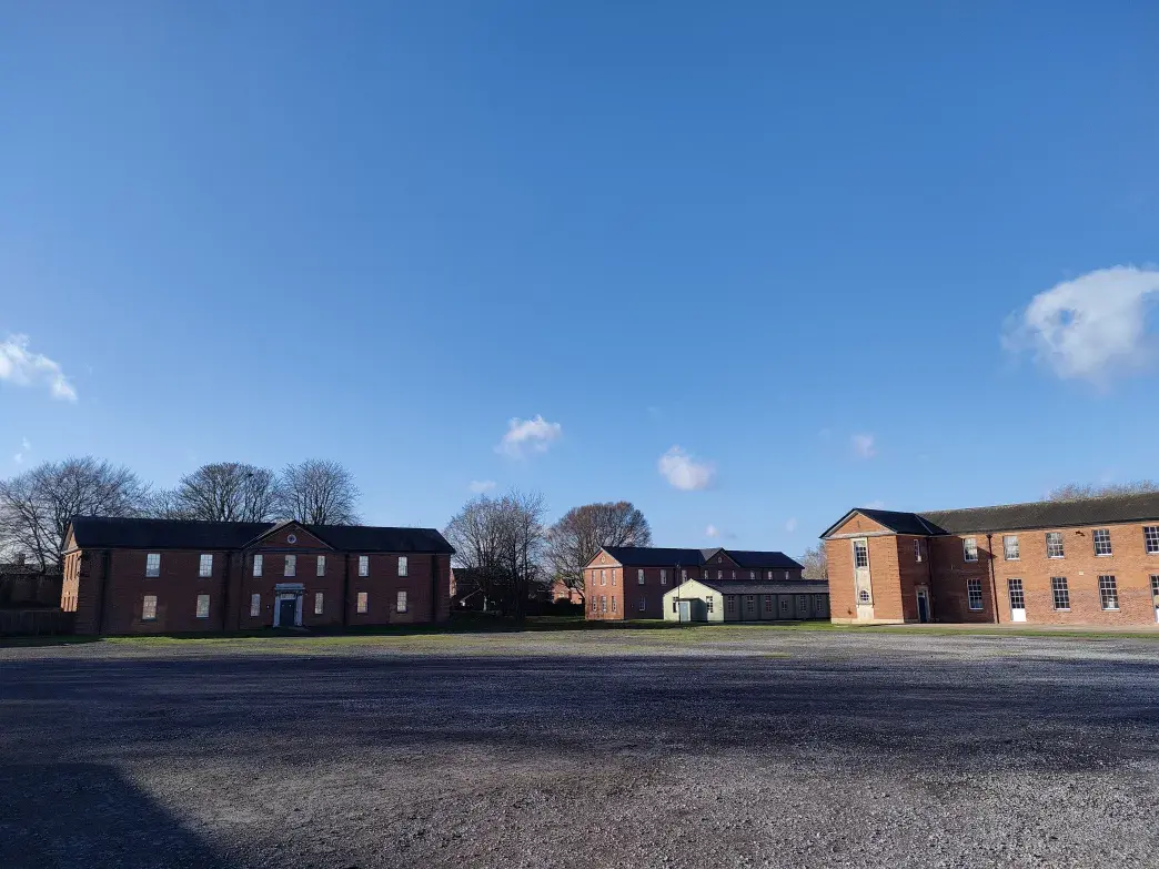 Exterior shot of bricked period buildings and paved area at IWM Duxford.