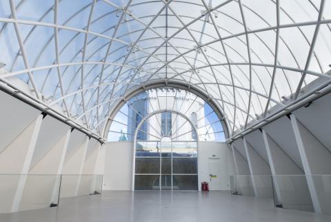 Wide, light, roof terrace with a glass roof.