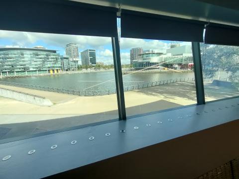View looking outside a window of canal waterfront and high rise office buildings.