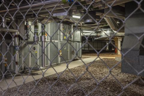 Industrial space at IWM North shot behind a metal fence