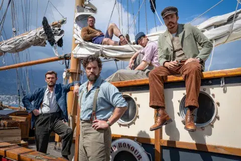Cast of Ministry of Ungentlemanly Warfare stood on the deck of a boat.