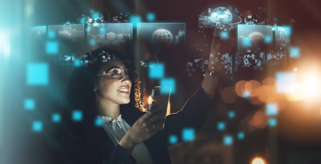 “A woman holding a smartphone smiles while interacting with glowing digital icons floating in the air, including symbols for global connectivity, wireless networks and data. The scene has a futuristic, technology-focused atmosphere with blue holographic elements and blurred lights in the background.