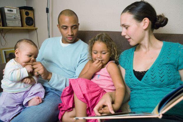 Young family reading books together