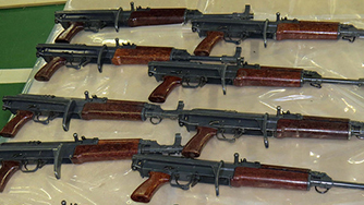 Eight firearms laid out on table