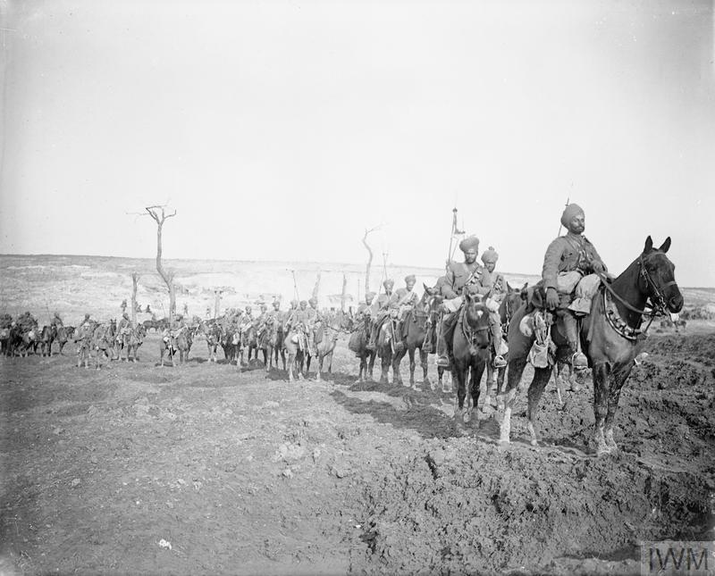 Troops of the 29th Lancers Regiment (Deccan Horse) near Pys, armed with lances and making their way through a shell torn landscape, March 1917.