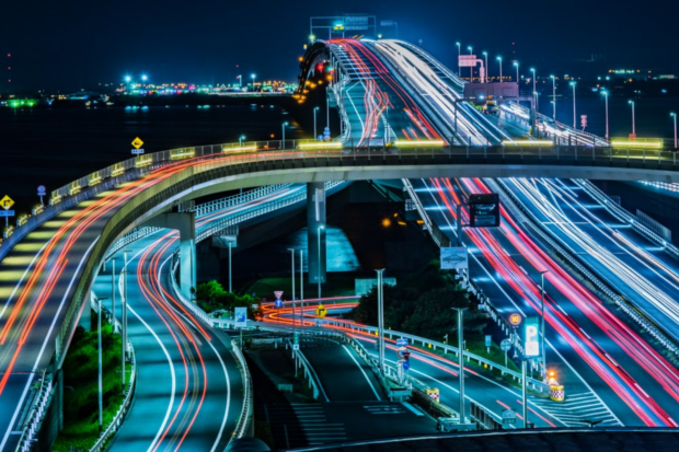 Neon lights showing night-time traffic.