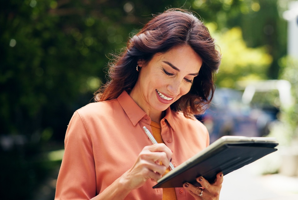 Image: People Images via Shutterstock Woman signing electronically for a service.