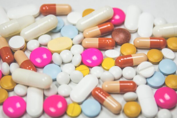 A variety of tablets and capsules of different shapes and colours
