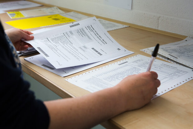 Image of person marking GCSE examination papers