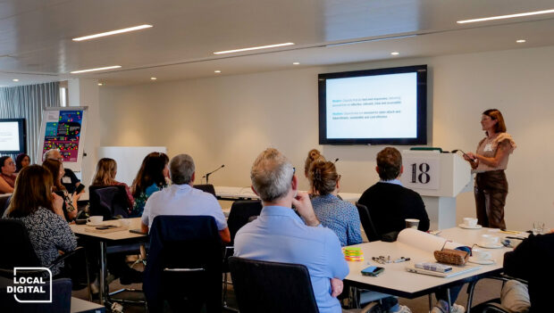 a room full of people listening to a presentation