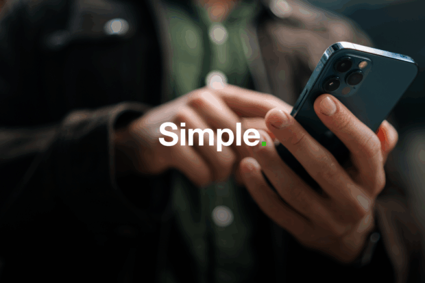 Someone is holding a phone, touching the screen, with the word 'simple' laid over the top