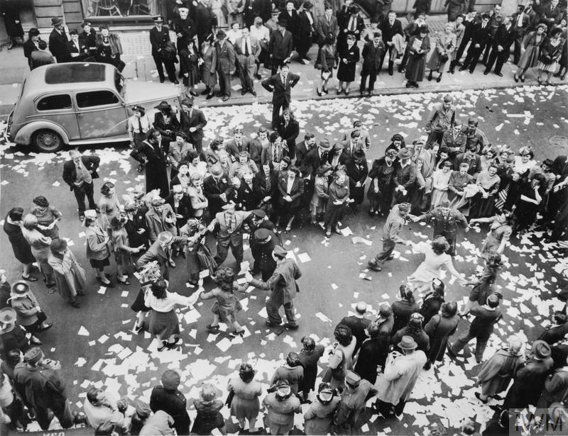 Soldiers and girls dancing in a street near Berkeley Square.