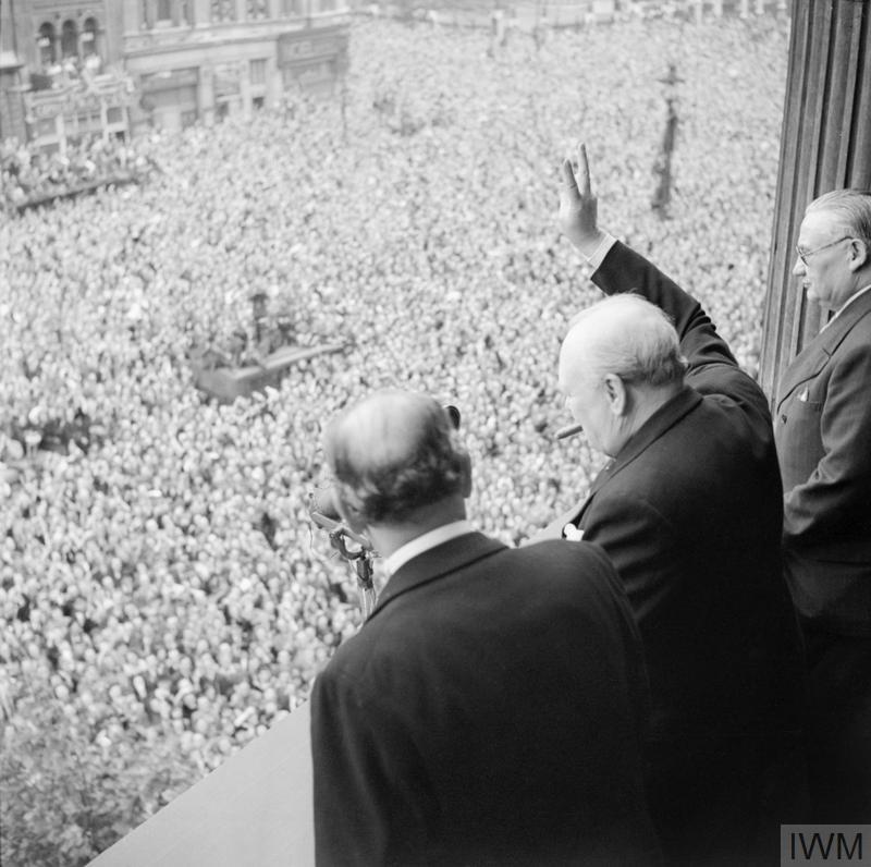 Churchill waves to crowds in Whitehall on the day he broadcast to the nation that the war with Germany had been won, 8 May 1945.