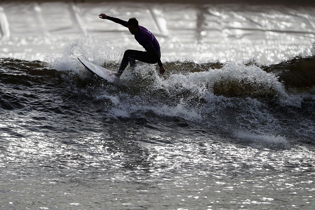 Surfer cresting a wave