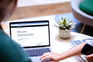 A person using a laptop to look at the GOV.UK proposition on the GOV.UK website
