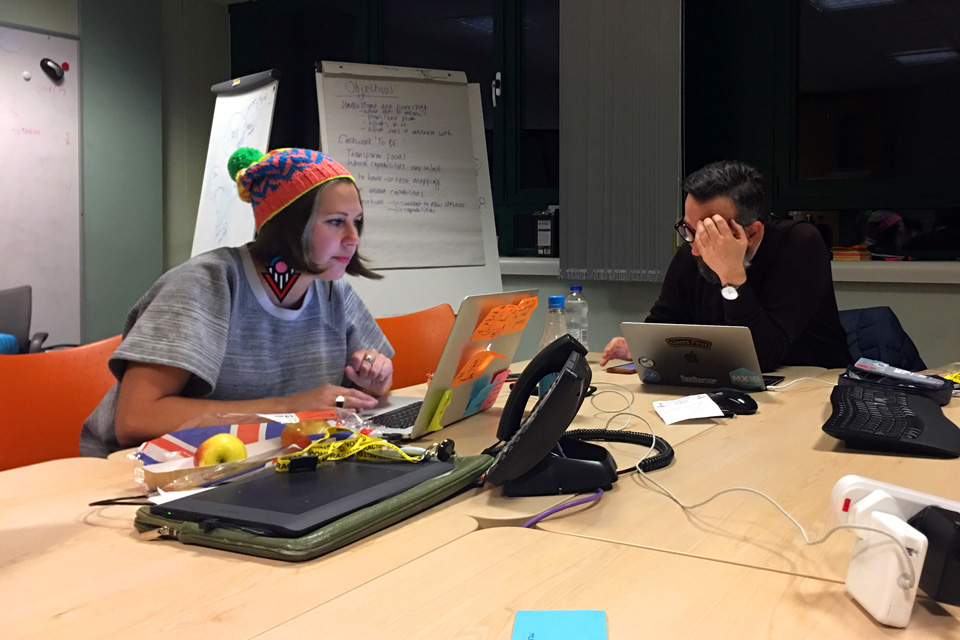 Two colleagues working on laptops