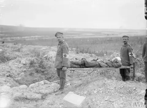 Two men of the German Red Cross carrying a wounded British soldier during the Battle of Albert.