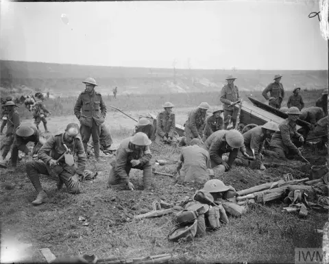Group of British troops digging themselves in by using entrenching tools, Mametz Wood, 17th July 1916.