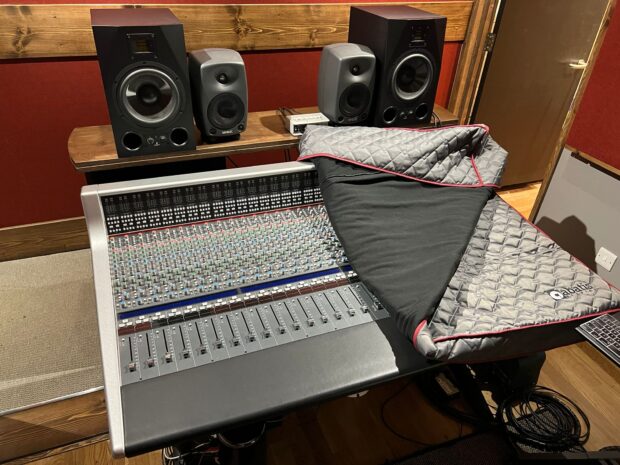 Recording studio setup showing a detailed mixing desk with ARB Covers designs bespoke quilted cover.