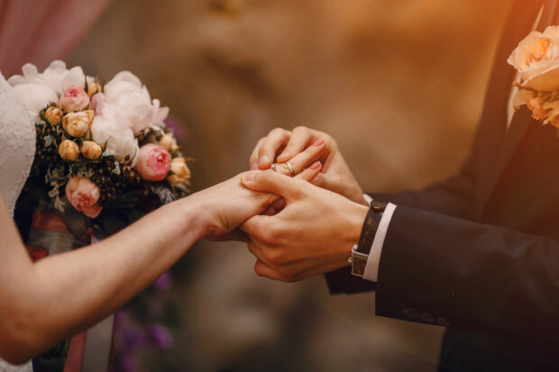 Bride and groom exchanging rings