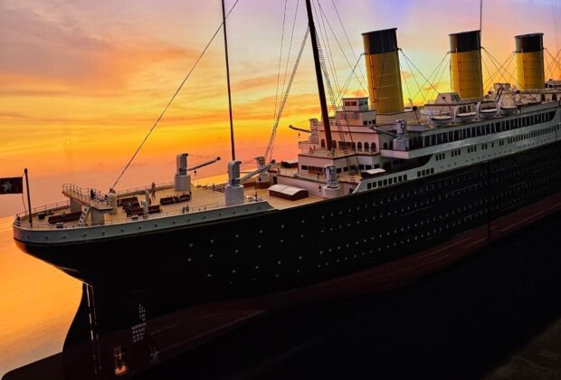 An image of a titanic model against a sunset background