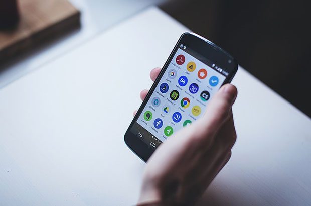 Mobile phone with app menu on the screen.