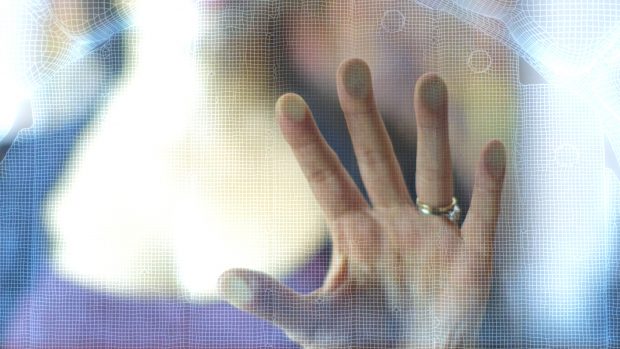 A hand using a mid-air haptic interface.