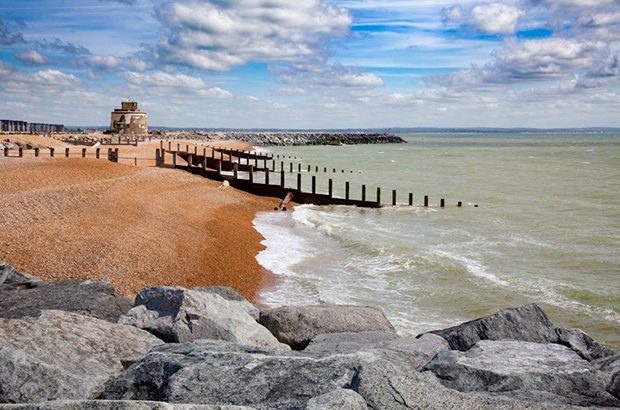 Stretch of coastline under blue sky.