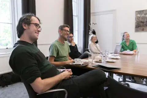 A group of CDP students sat around a table talking