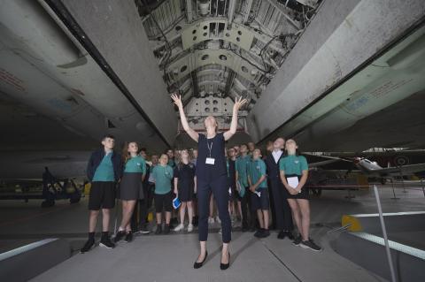 School students look up underneath an aircraft at IWM Duxford
