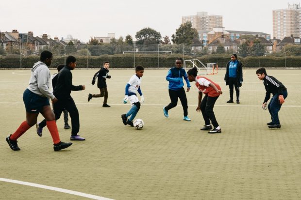 Group of young children participating in football training