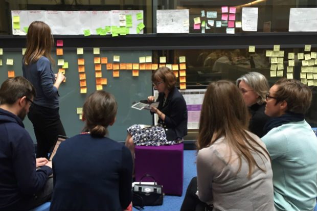 Picture of a group of colleagues sharing work insights