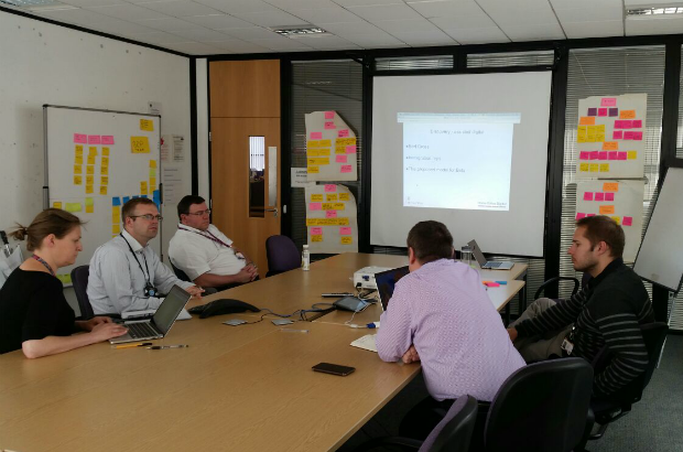 Team members sitting around a table in a meeting