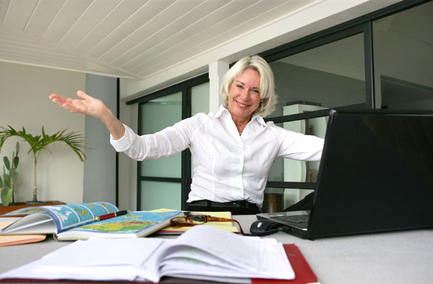 Image of business woman sat at her desk.