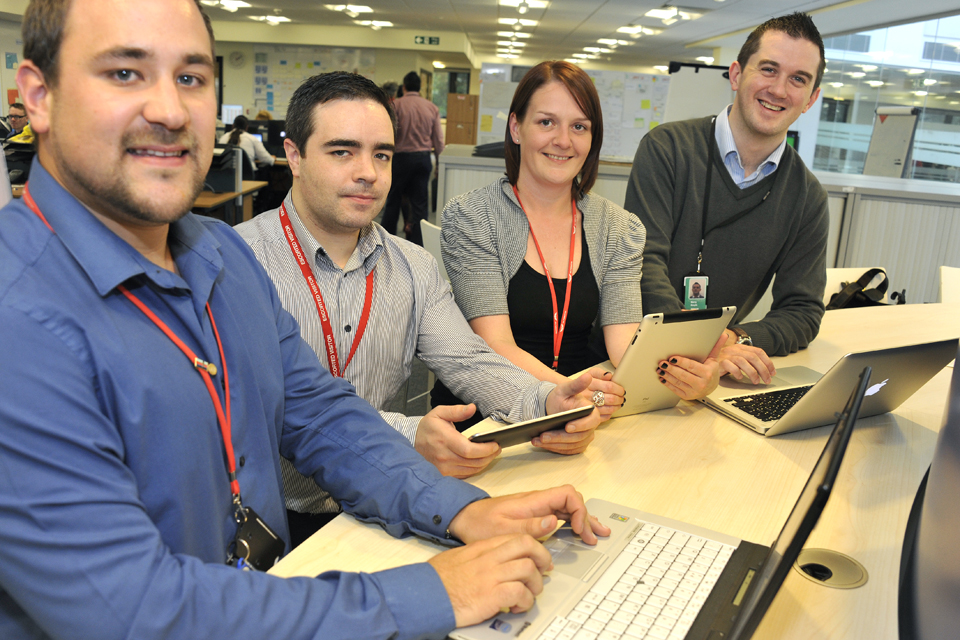 Agile project team members looking at their laptops