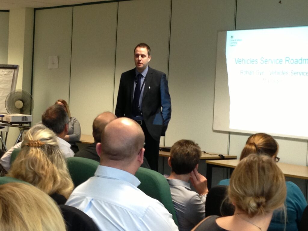 Rohan Gye standing in front of a screen presenting an overview of DVLA’s strategy
