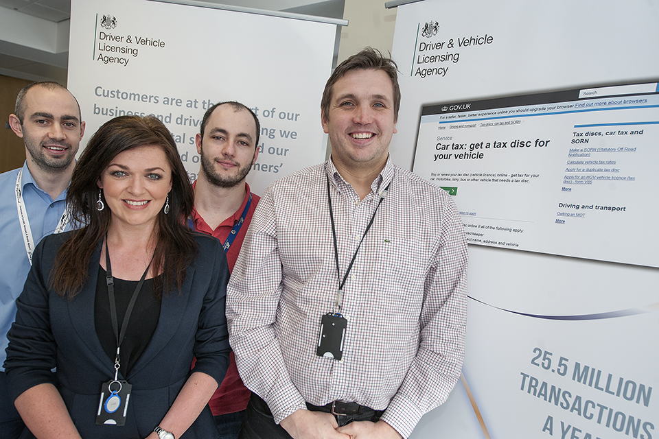 Team members in front of the service screen
