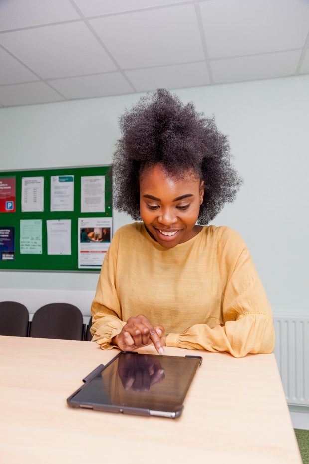 Girl using an ipad on a desk