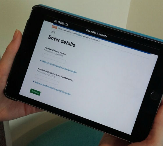 person holding a tablet showing the start page for the service