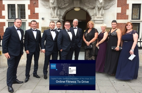 the team standing together outside a building at the awards