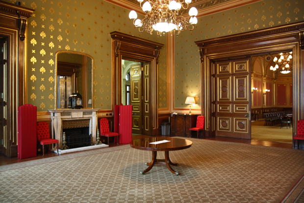 A grand room in the Foreign Office - A dining room with wall paper glistening with golden decoration and brand new carpet.
