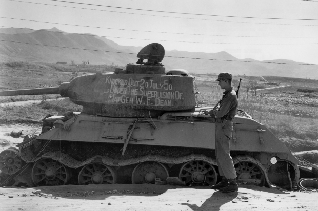 A solder stood next to a captured Russian Tank.
