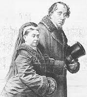 Queen Victoria is walking arm in arm with Disraeli in this drawing. Disraeli is holding his hat with his other arm. 