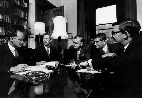 A group of officials (men in suits) in conversation