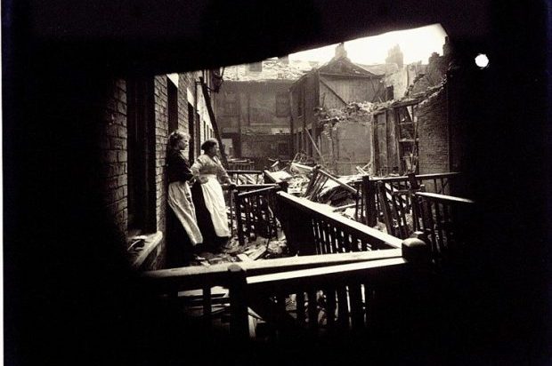 Damage caused by the raid to Edwin Place, Porter Street, Hull, 1916. Two women stand together outside a house looking upon a scene of devastation.