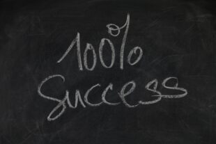 Blackboard with 100% success written on it